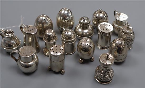 A pair of silver weighted egg-shaped 'cayenne' and 'pepper' pots, crested and fourteen other silver peppers,